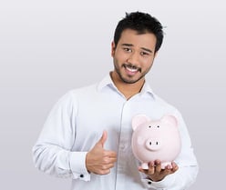 Closeup portrait of young smiling student, worker man holding piggy bank, giving thumbs up, isolated on white background. Smart currency financial in
