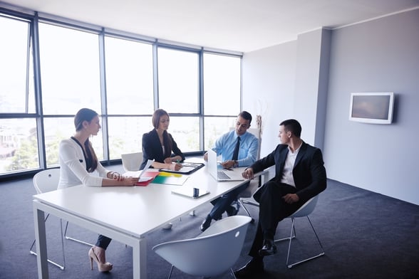 Group of happy young business people in a meeting at office