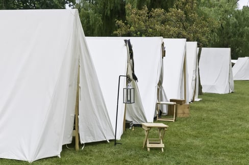 Row of white tents in a camp