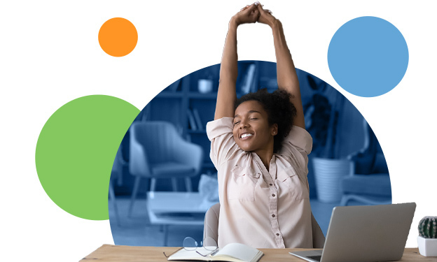 Woman stretching at her desk, feeling relaxed after simplifying reporting and administrative tasks.
