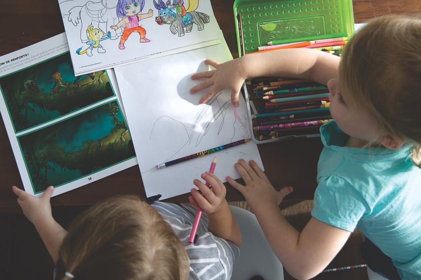 Image of Two preschoolers drawing and coloring together
