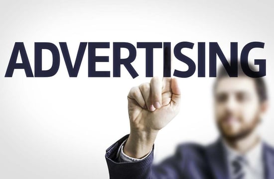 Business man pointing to transparent board with text Advertising