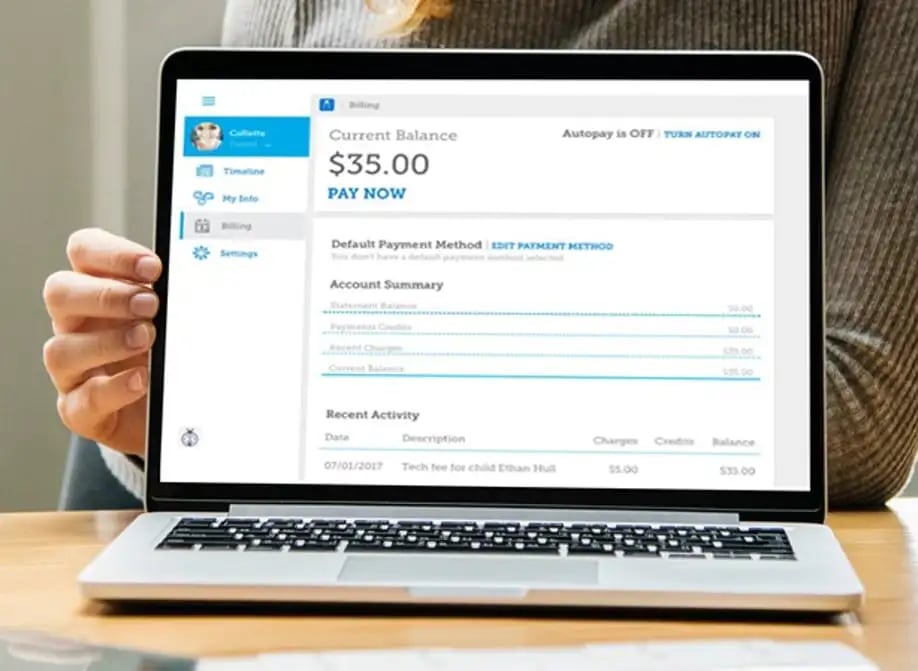 Laptop displaying Smartcare online account management interface with current balance and payment options.
