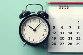 Alarm clock and calendar symbolize time management and scheduling.