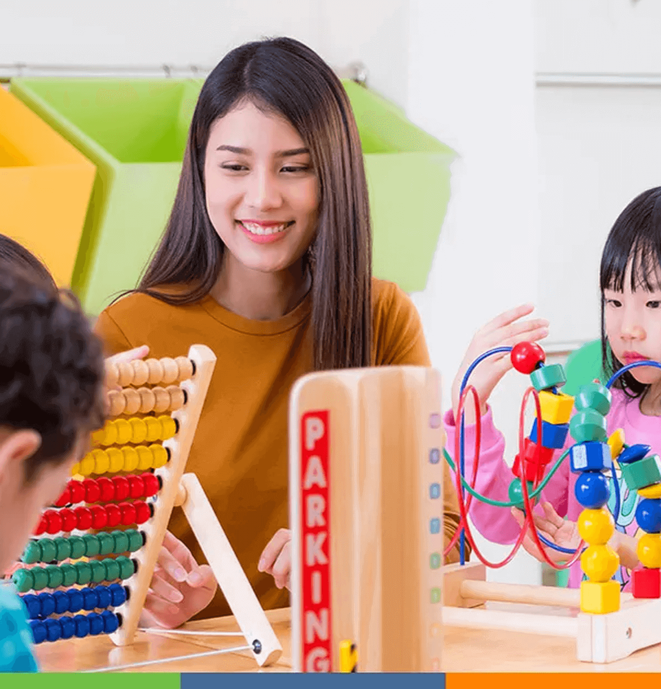 early childhood teacher with children at table
