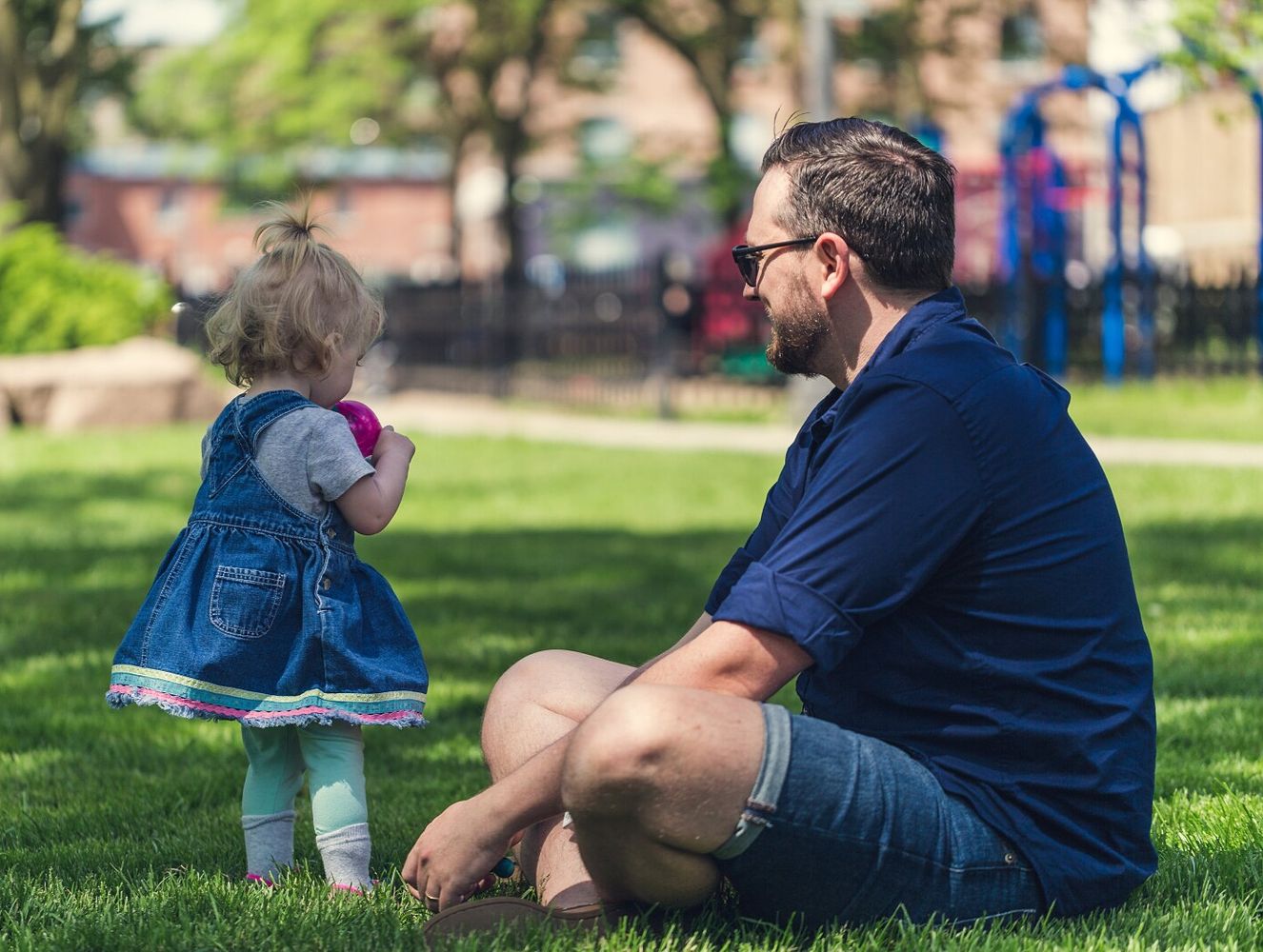 Parent with child at playground after daycare