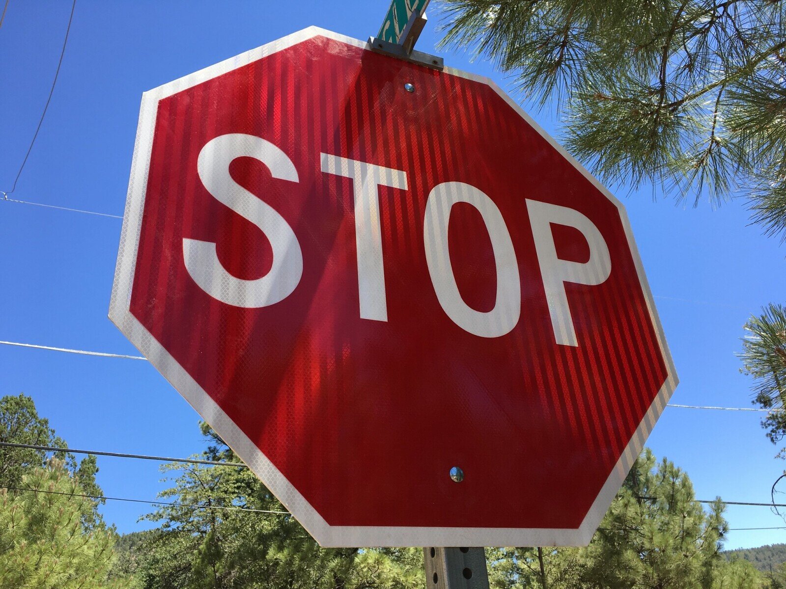 Image of a stop sign near a school parking lot