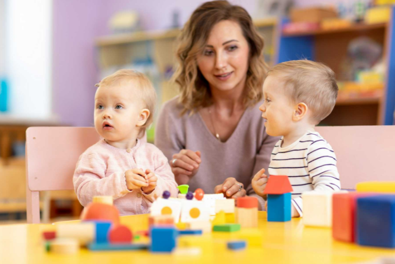 Daycare teacher playing with students