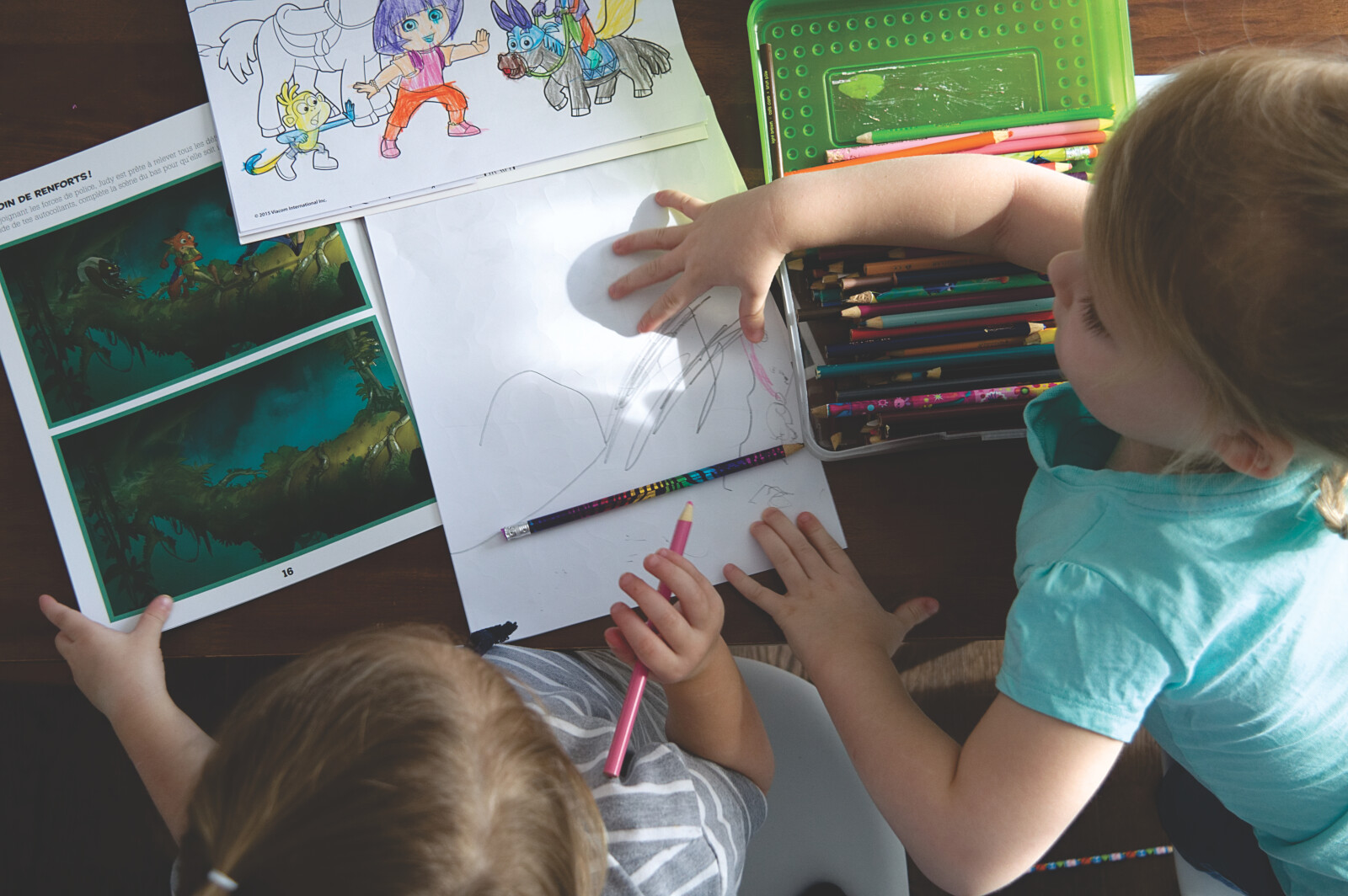 Image of Two preschoolers drawing and coloring together