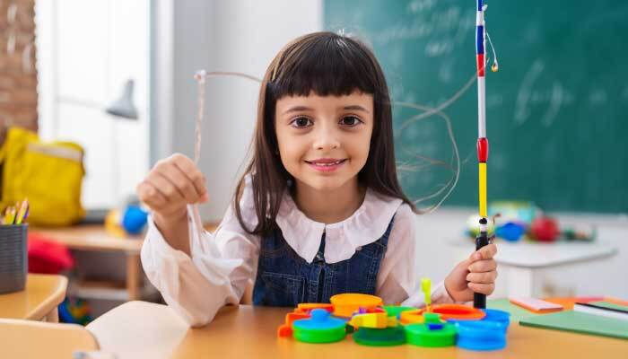 girl holding toy fishing rod