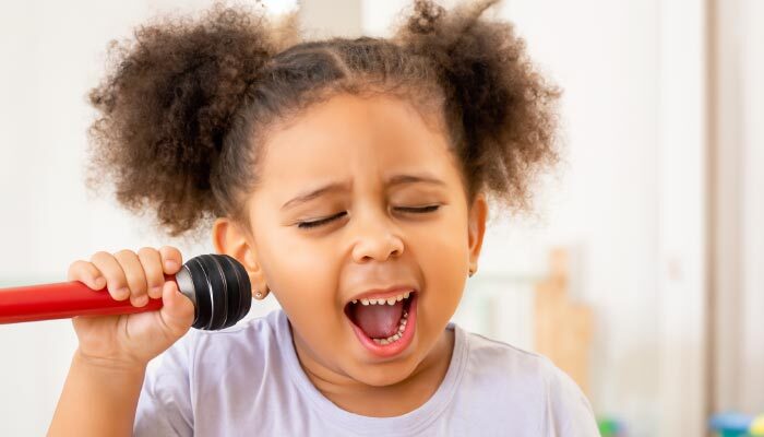 preschool child singing nursery song